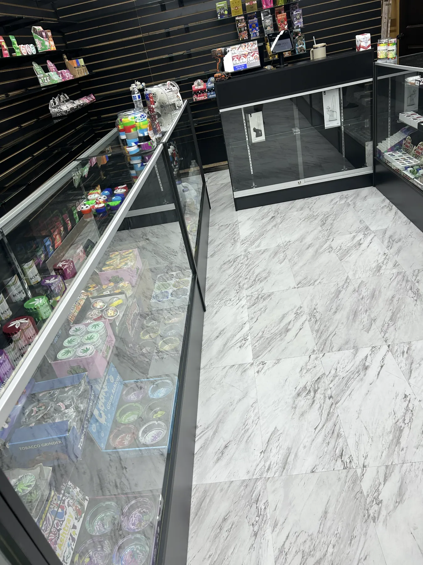 Organized glass display counters inside Imperial Beach Smoke and Market