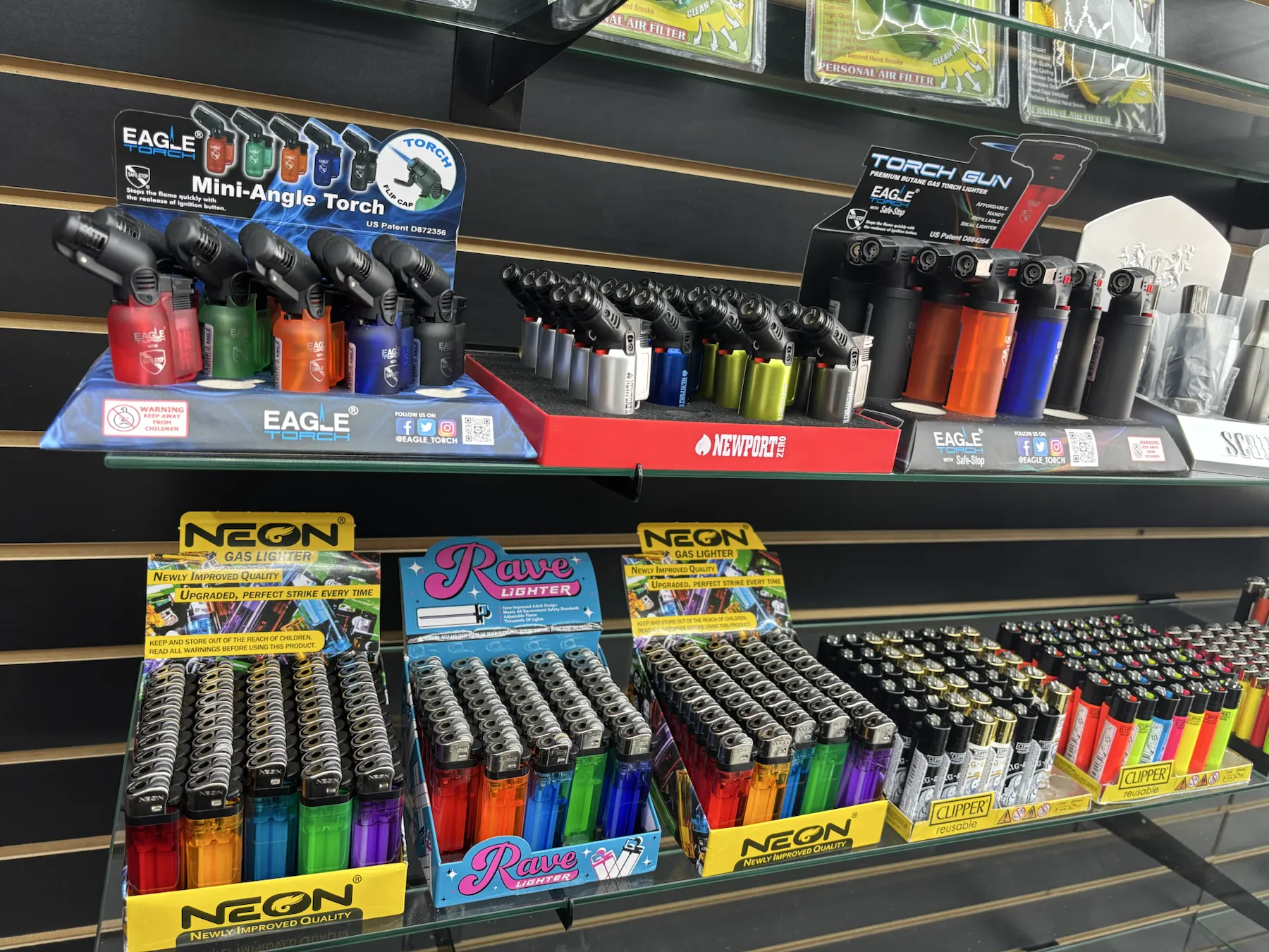 Assorted lighters and refillable torches in many colors